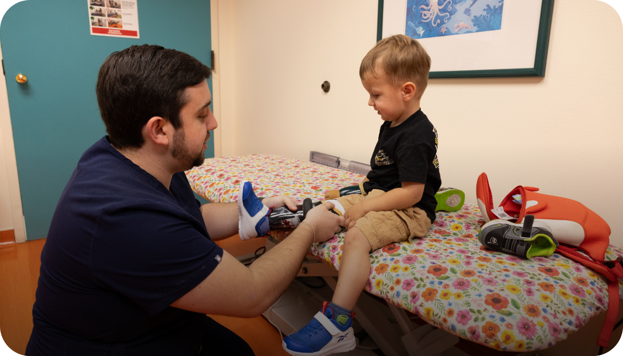 child being outfitted with prosthetic leg